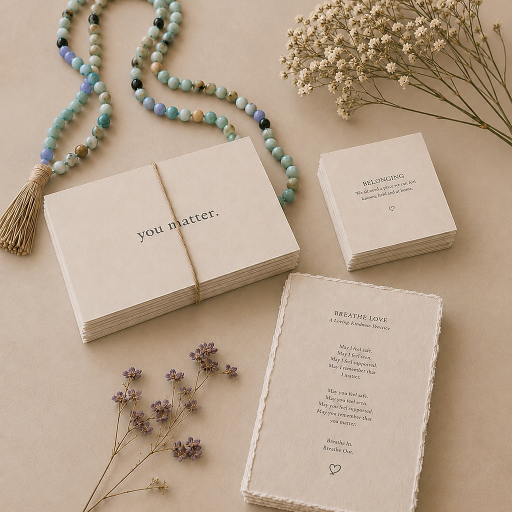 Breathe Love cards, beads, and delicate flowers arranged in warm natural light.