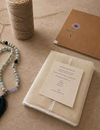An open Breathe Love package holding cream textured cards tied with brown twine beside cream envelopes in warm window light.
