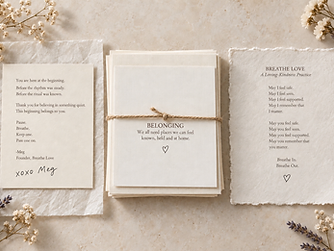 Breathe Love welcome note, belonging cards, and a loving-kindness practice arranged on linen in warm natural light.