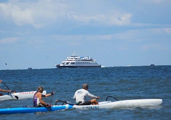 Paddlers and the Cape May–Lewes Ferry off the Delaware coast
