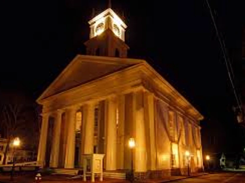 The Old Whaling Church, Edgartown, lit amber against a black night sky