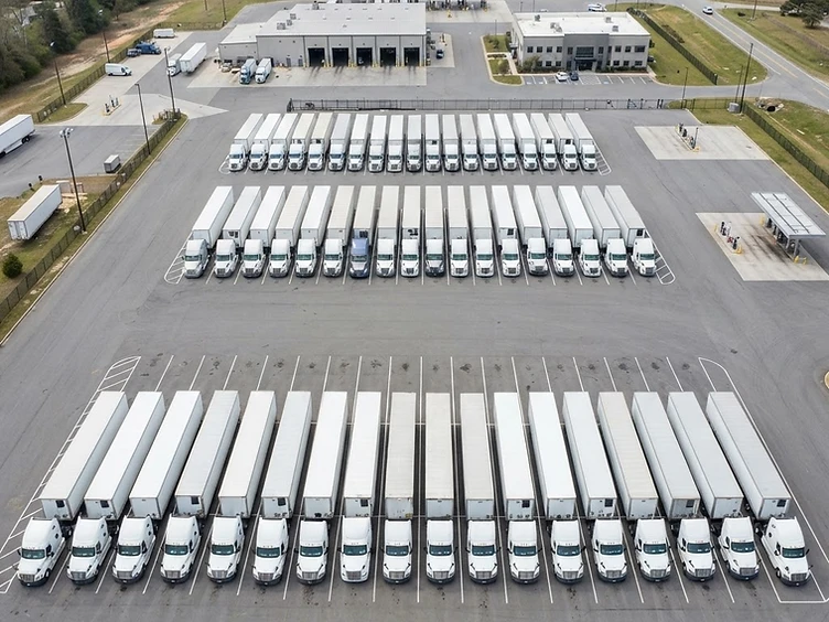Row of semi trucks at a professional facility
