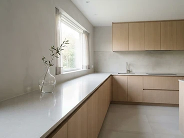 A freshly deep-cleaned minimalist kitchen with a spotless stone countertop