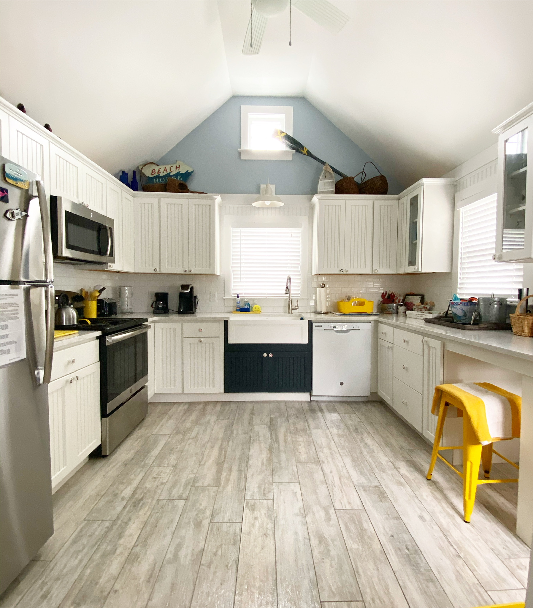 Cape Cod rental kitchen with vaulted blue ceiling and farmhouse sink