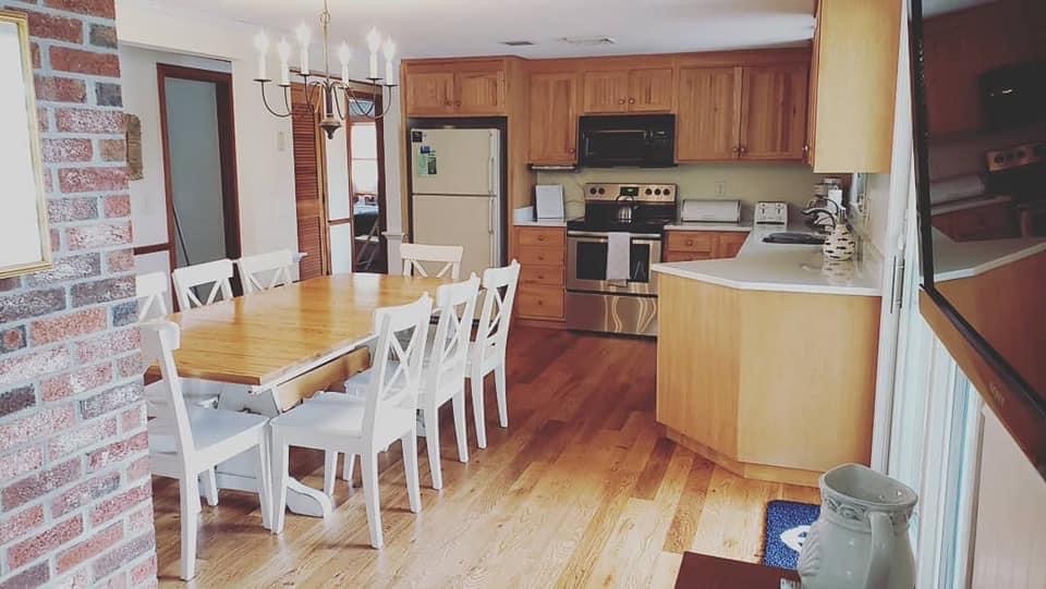 Open-concept dining and kitchen area in a Cape Cod rental