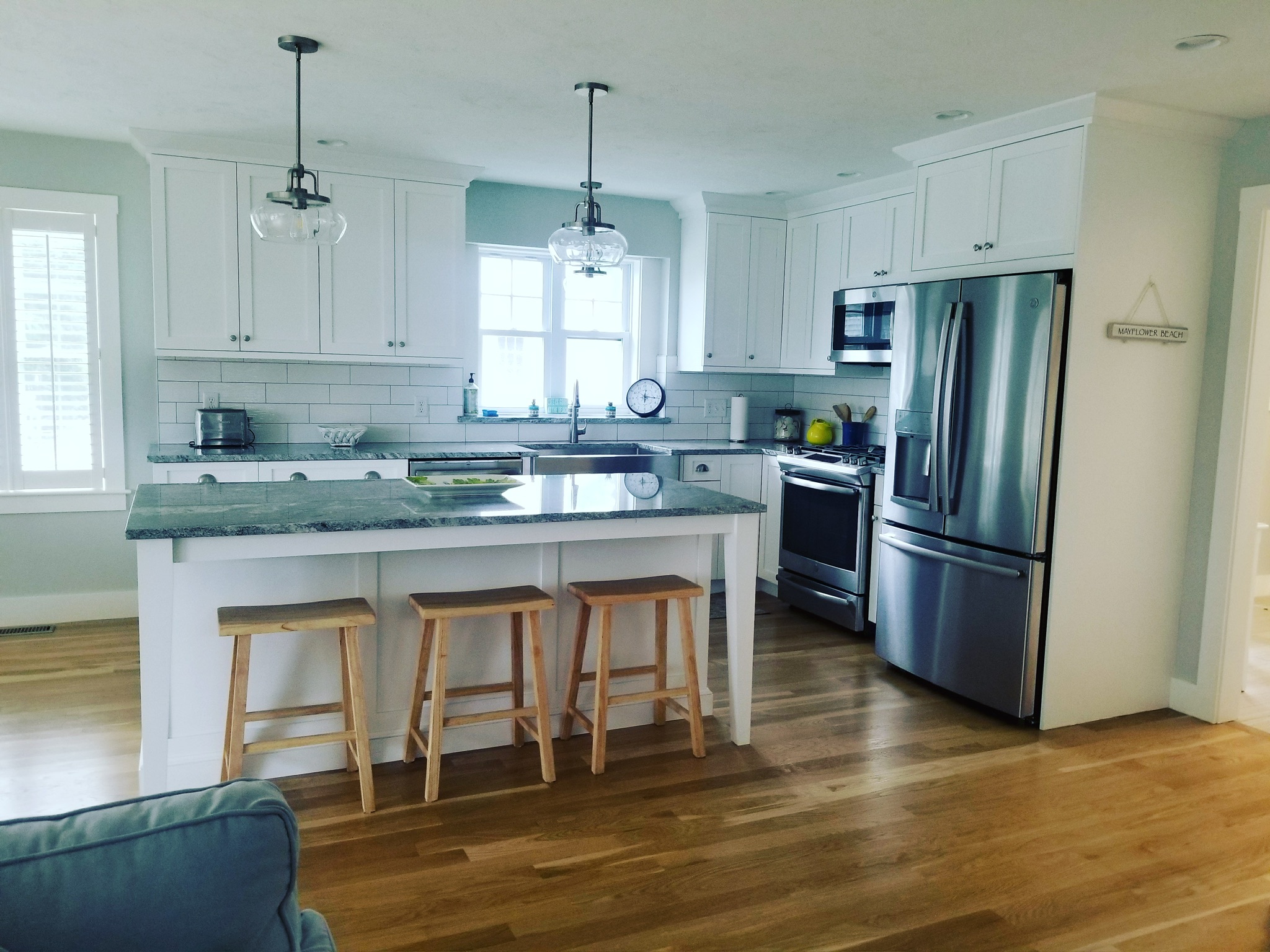 Bright modern Cape Cod rental kitchen with white cabinetry and central island