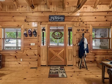 Interior front entrance area with pine log walls