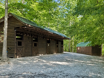 Honeycutt Hollow stables and stalls among the trees