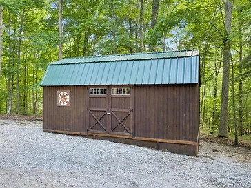 Green-roofed storage shed with quilt-patterned decor