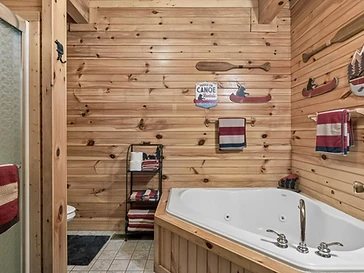 Log-cabin bathroom with jetted tub and rustic decor