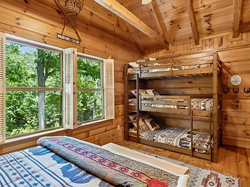 Bedroom with triple bunk beds and geometric bedding