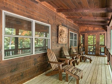 Screened-in porch with wooden seating