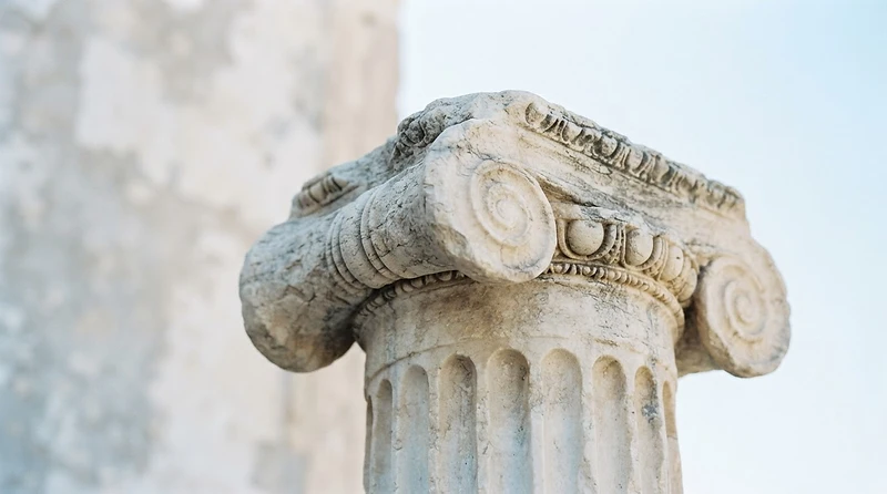Ancient Greek marble column capital in soft daylight