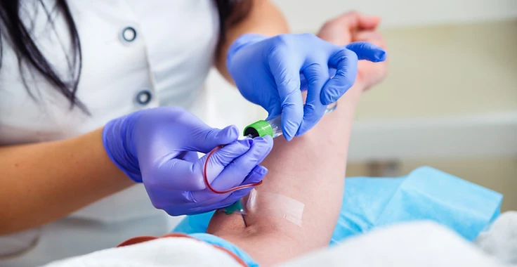 Mobile phlebotomy professional collecting a blood specimen