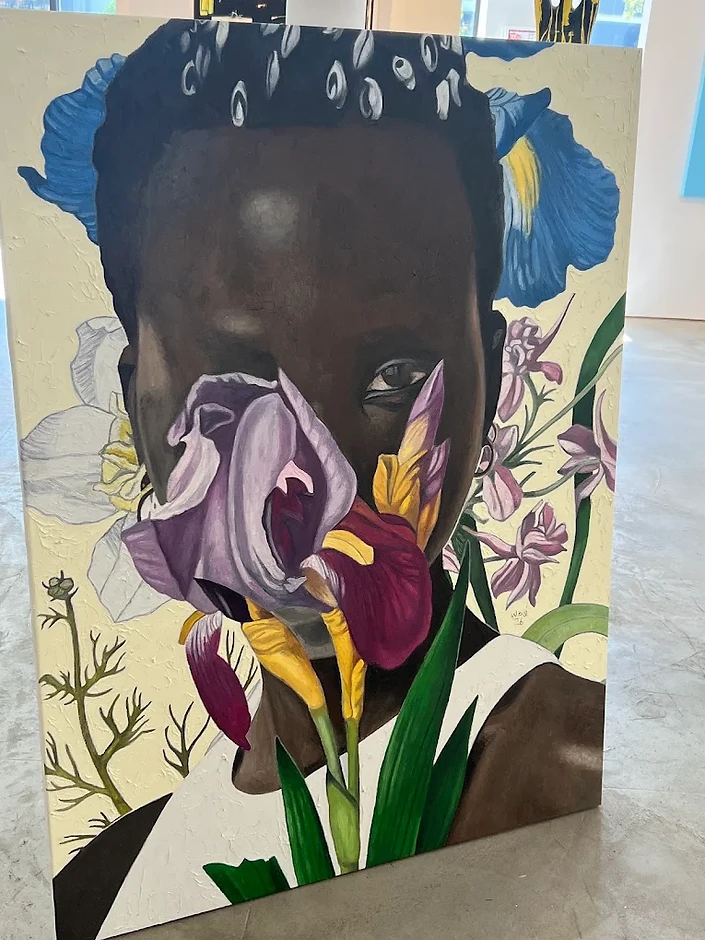 A custom-framed portrait painting of a figure with an iris flower, artwork courtesy of Alan Avery Art Company