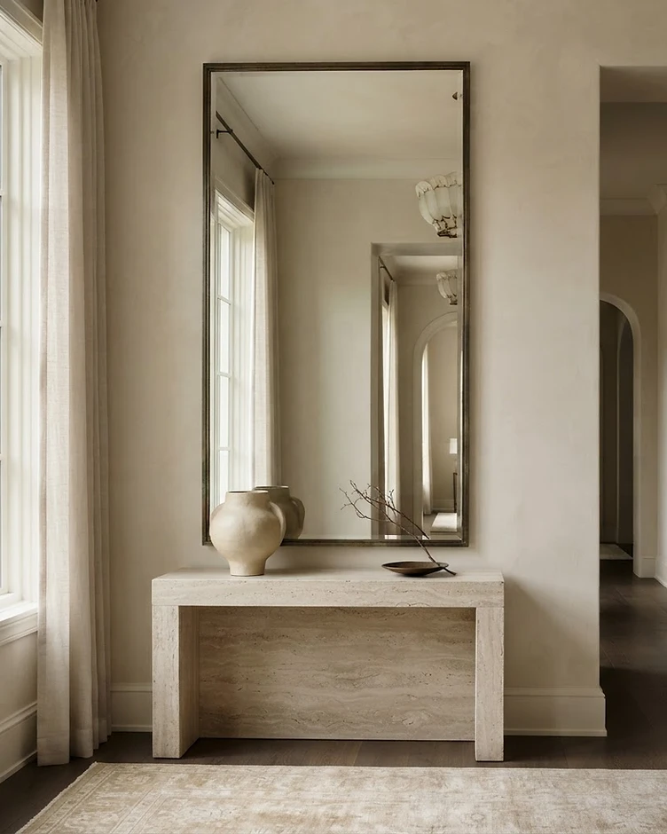 A large custom-framed mirror integrated into a high-end residential interior