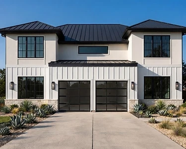 Modern white Texas home with a charcoal-black full-view aluminum garage door with clear glass, after