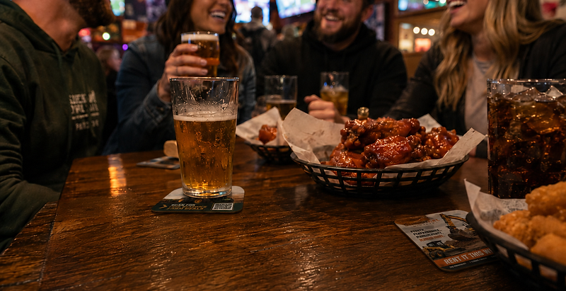 Customers enjoying drinks at a bar