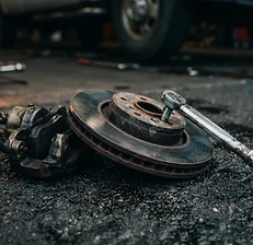 Brake rotor and caliper on wet asphalt