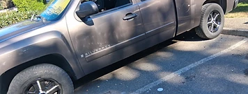 Dark metallic Silverado parked at an angle