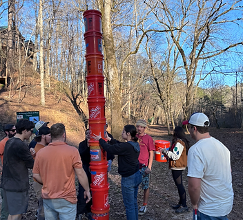 Team stacking buckets during a group challenge