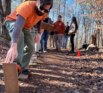Participants working through a board-walking challenge