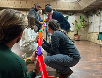 Hands coordinating during a team-building challenge