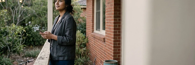 Woman checking divorce eligibility on her phone at home in Victoria