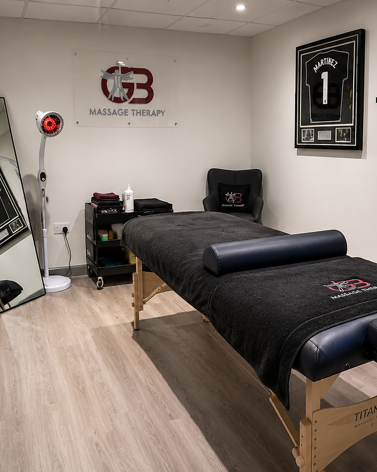George performing a deep tissue massage on a client's shoulder at GB Massage Therapy, Fort Dunlop
