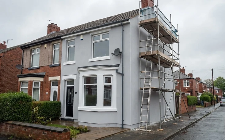Semi-detached house with newly applied pale grey silicone render