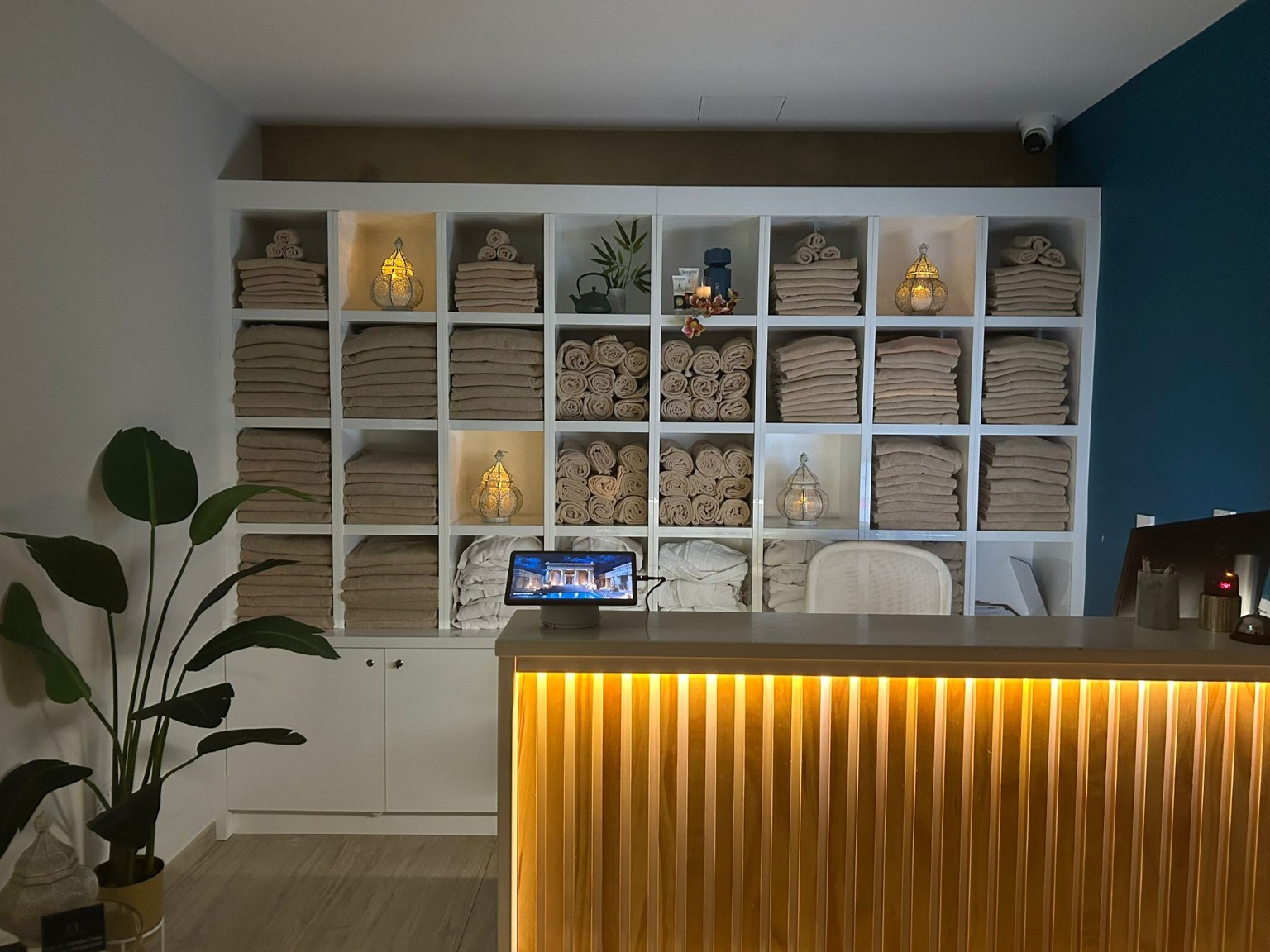 Bespoke spa reception desk and fitted towel-storage cabinetry by A&A Design.