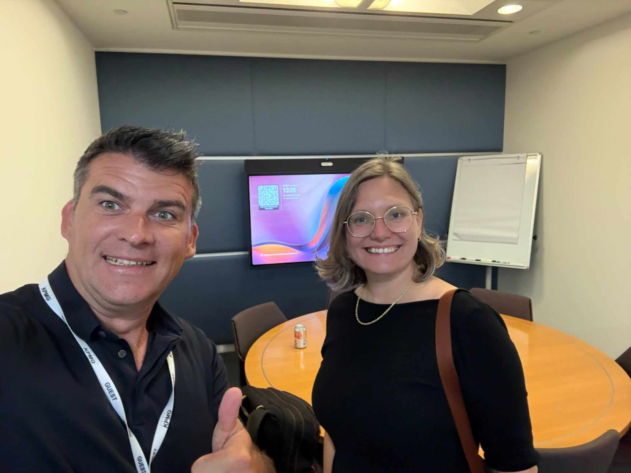 Two of the team in a conference room after a client session