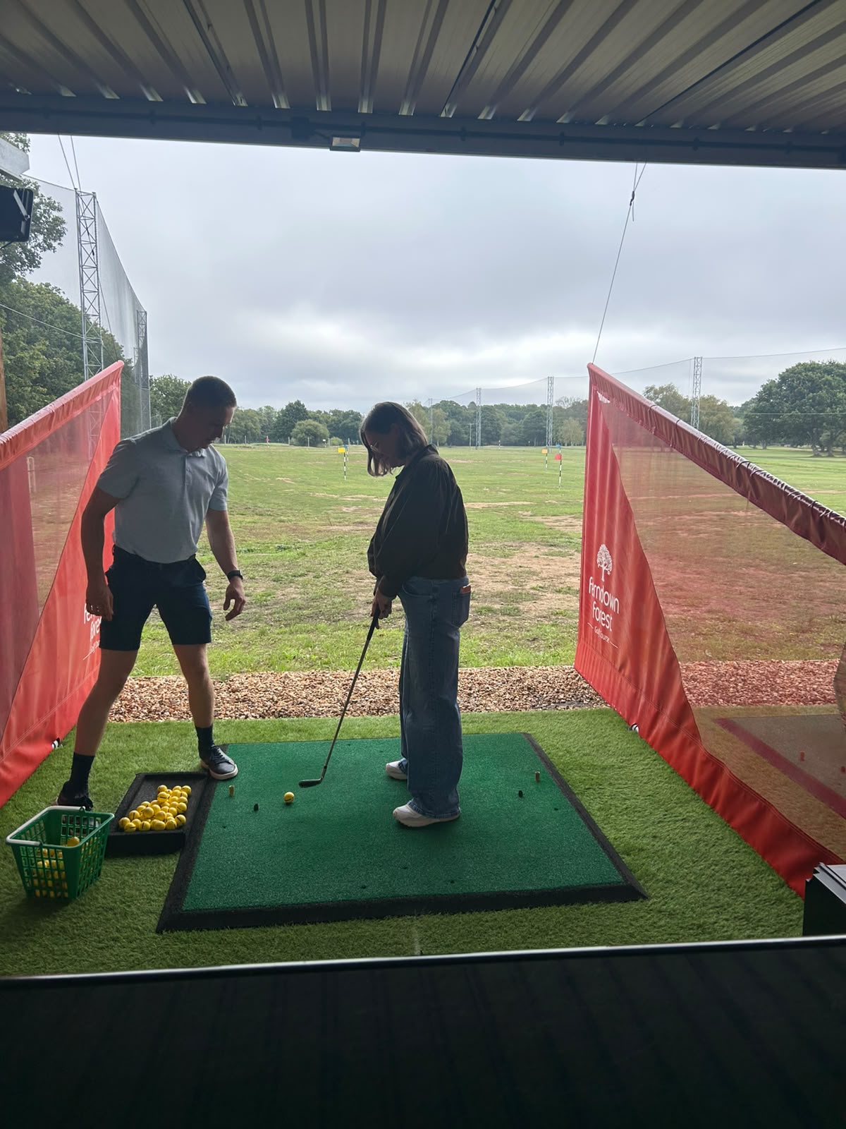 A golf lesson at the driving range on a team afternoon out