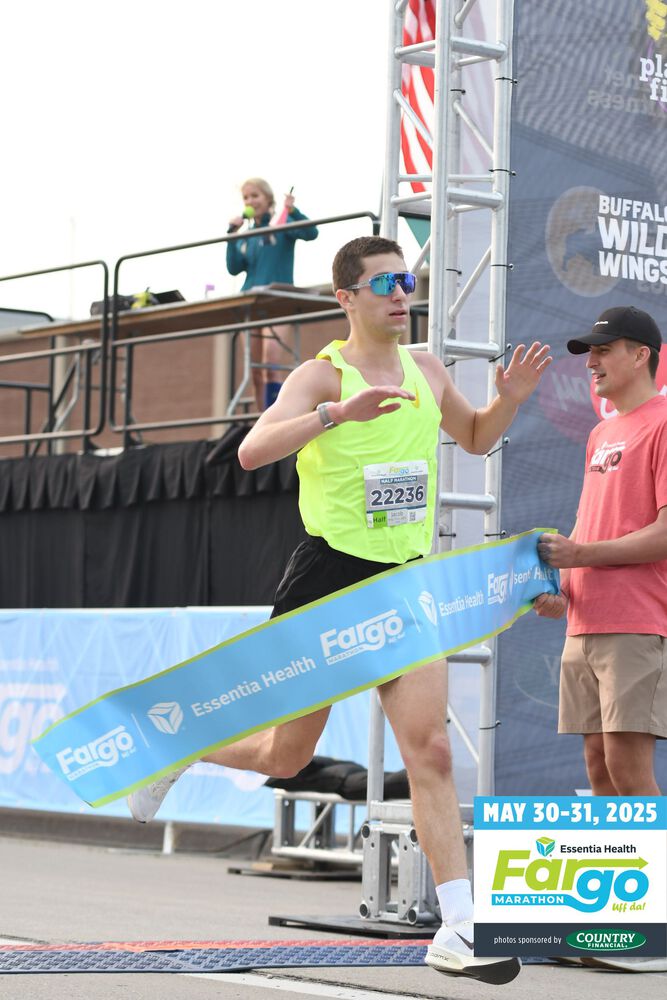 Jacob crossing the finish line at the Fargo Half Marathon