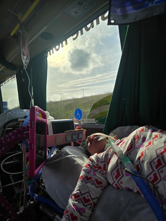 A passenger travelling on a bed on board a Jumbulance with medical equipment powered on board.