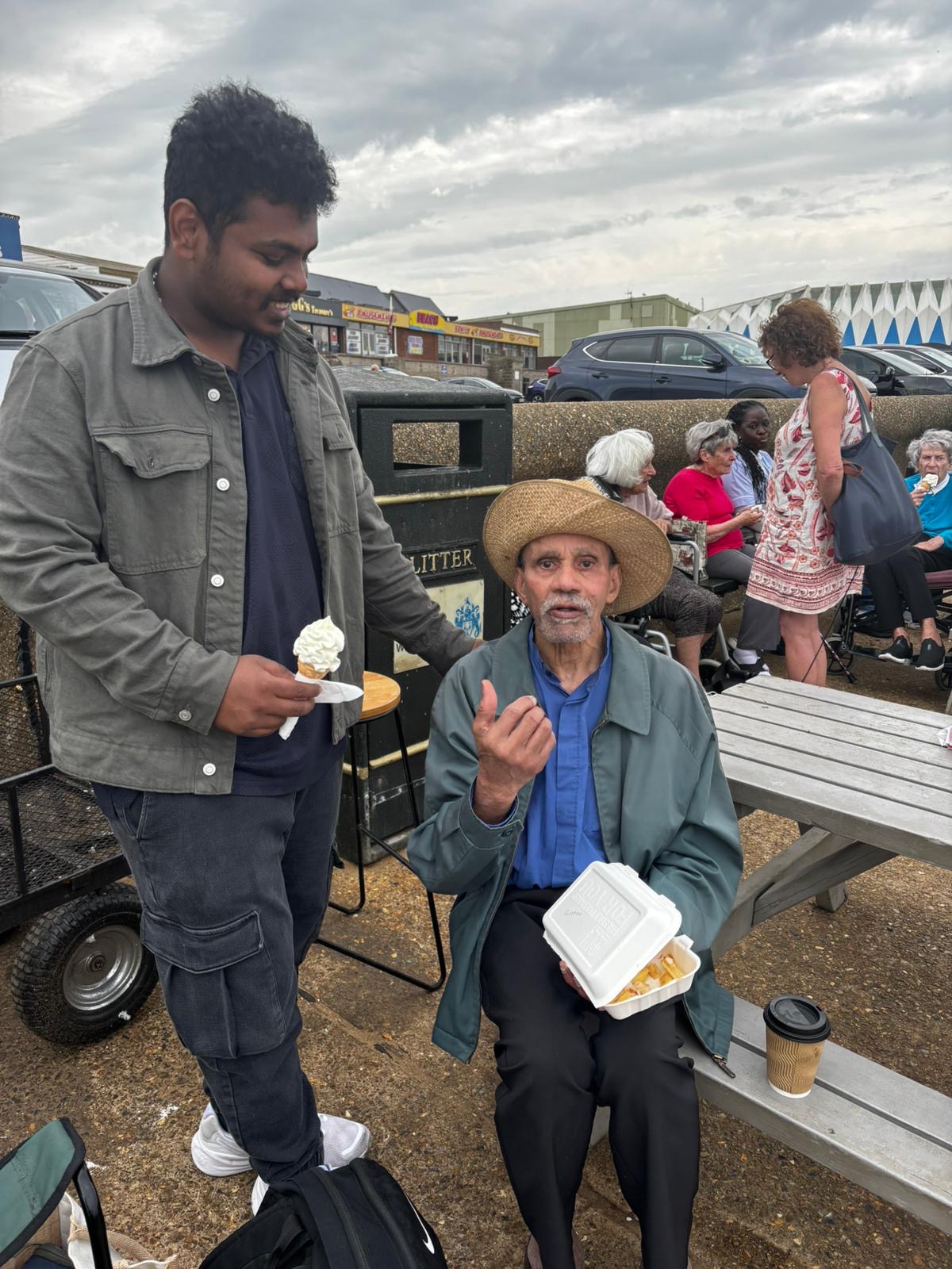 Travellers sharing a snack on the seafront