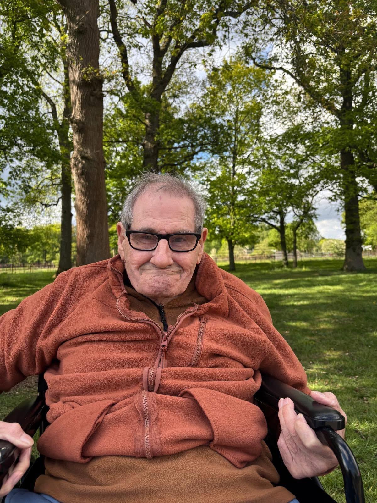 A traveller smiling in his wheelchair outdoors