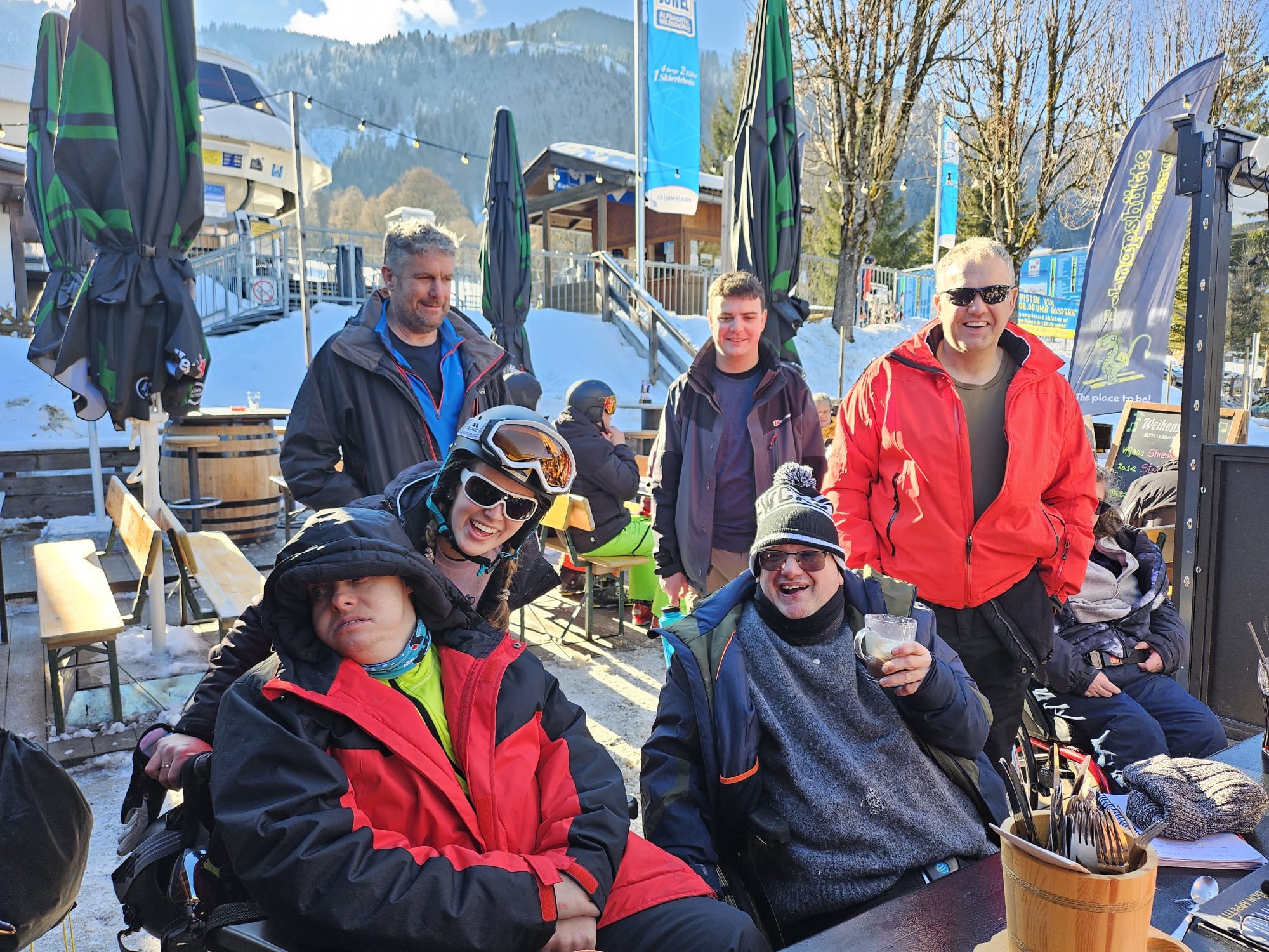 Travellers and volunteers on a ski resort terrace
