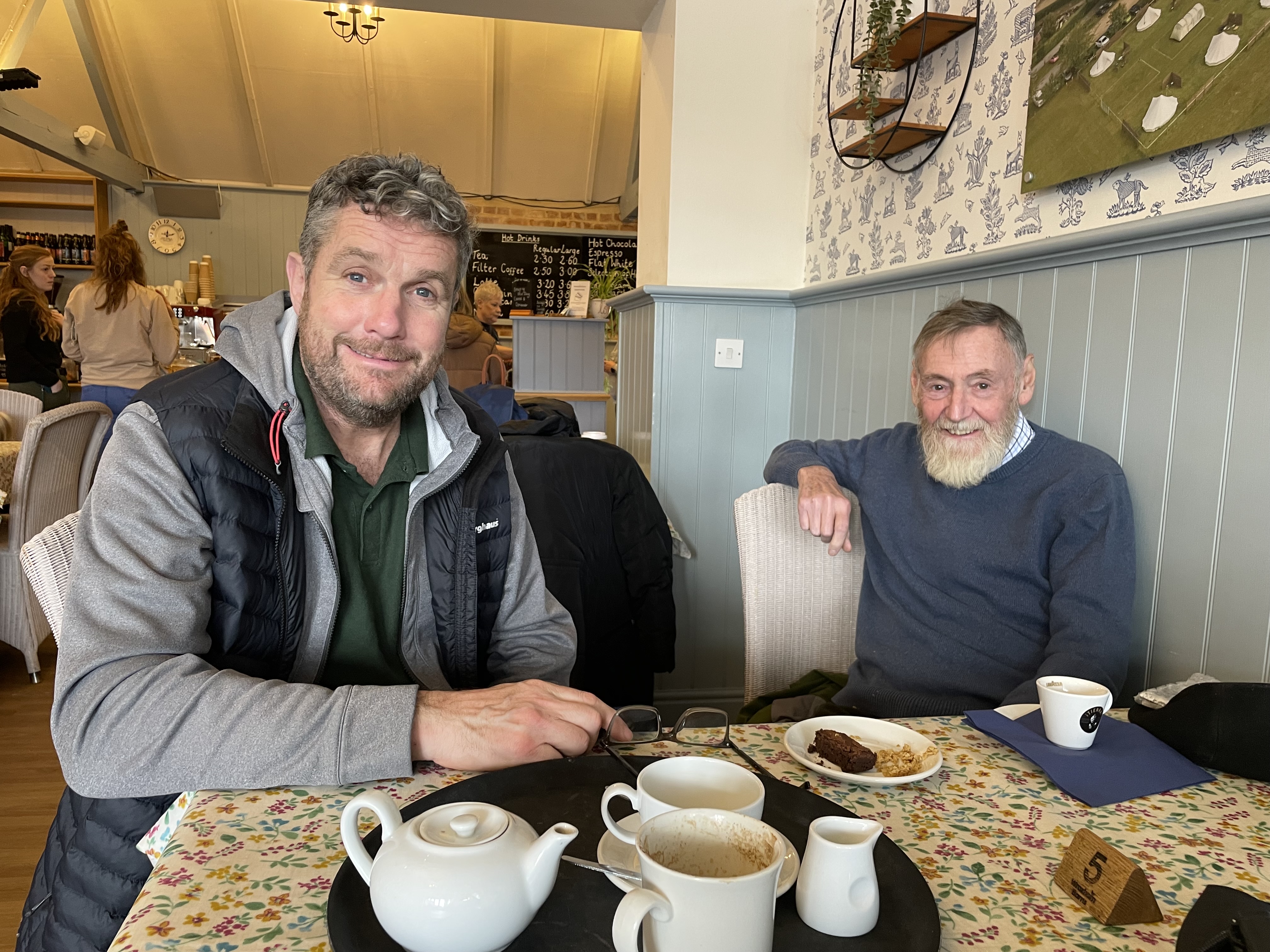 Two travellers enjoying tea and cake at a cafe