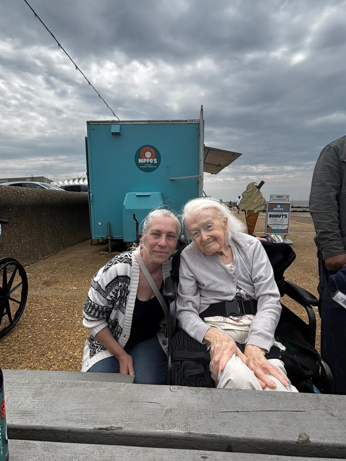 Two travellers at a seaside donut stand
