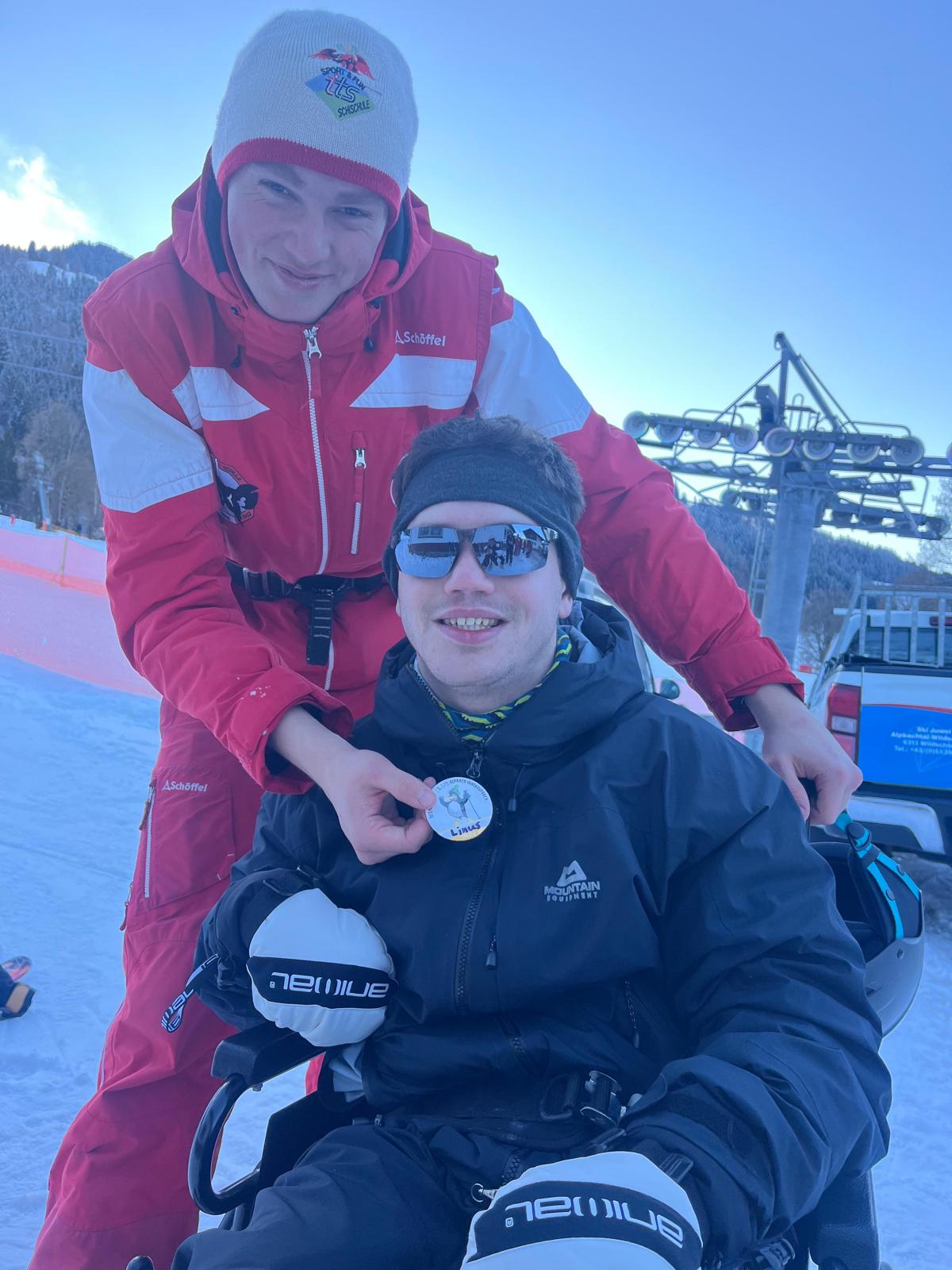 A ski instructor with a traveller on the slopes