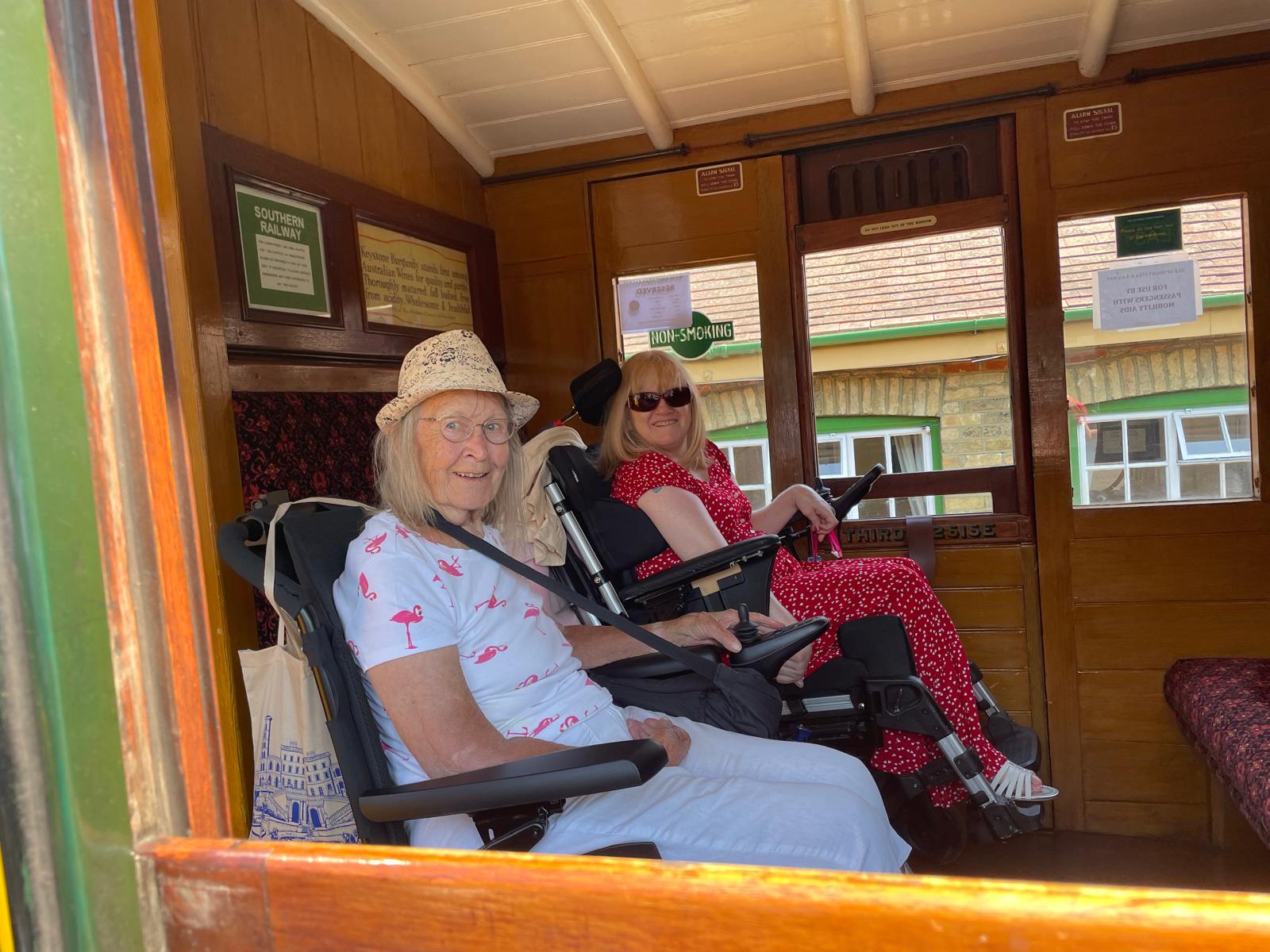 Two travellers in a heritage railway carriage