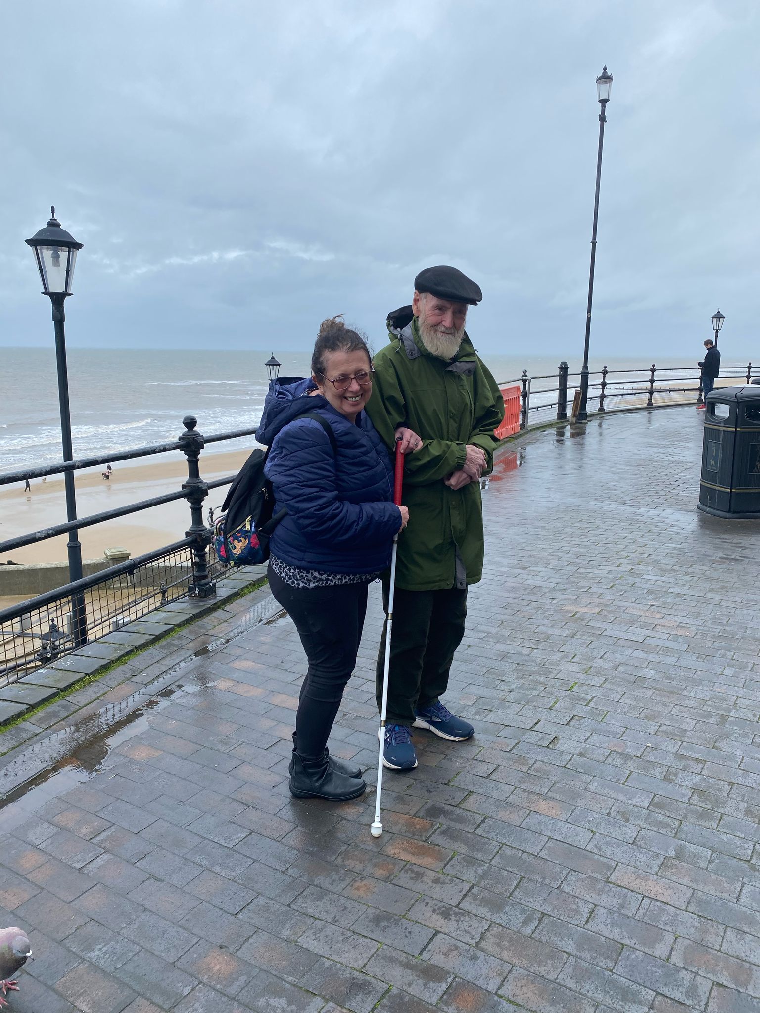 Two travellers on a seaside promenade