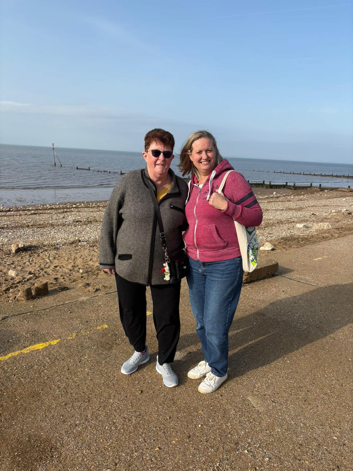 Two volunteers on a seaside promenade