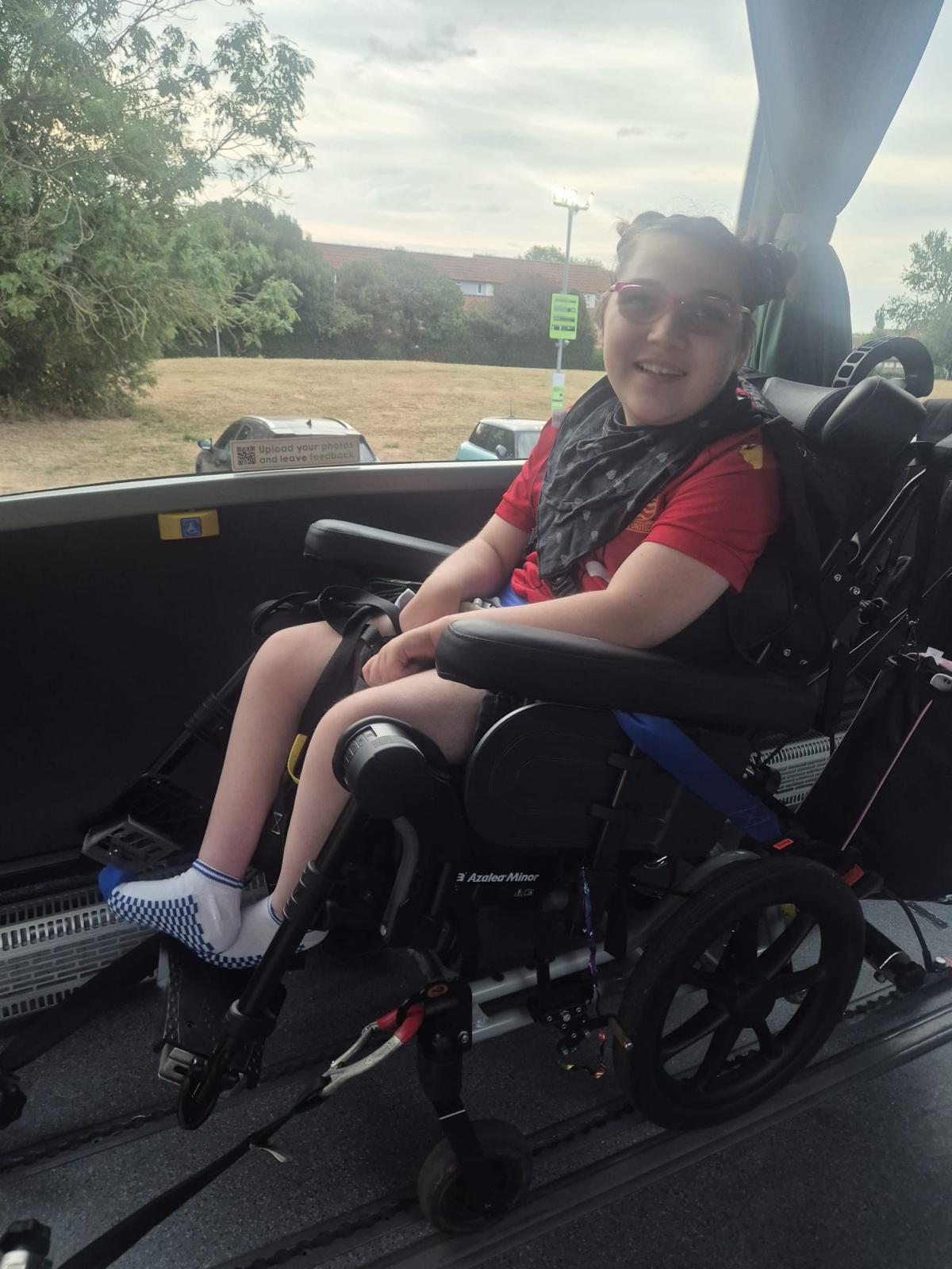 A traveller in her wheelchair on board the Jumbulance