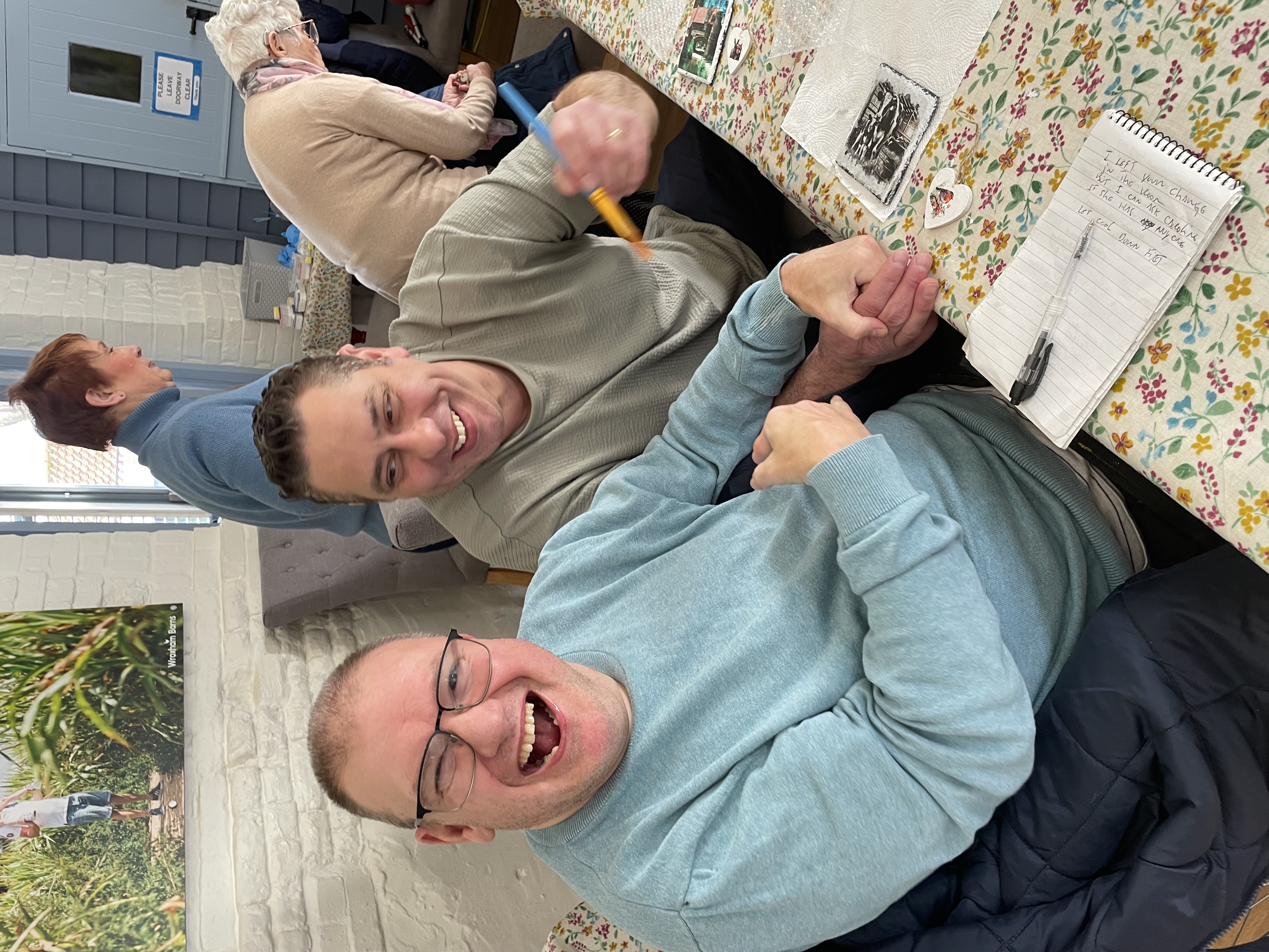 Volunteers enjoying a craft activity together at a table
