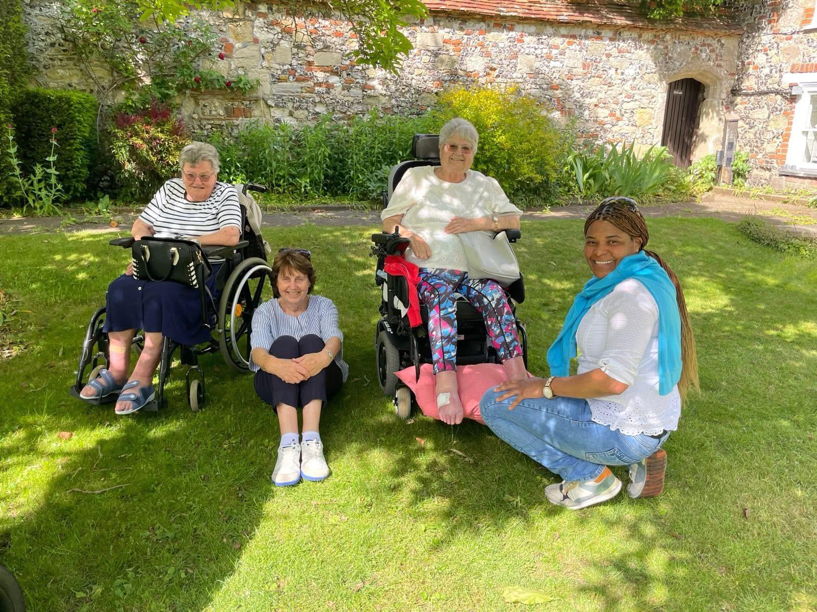 Travellers posing together in a garden