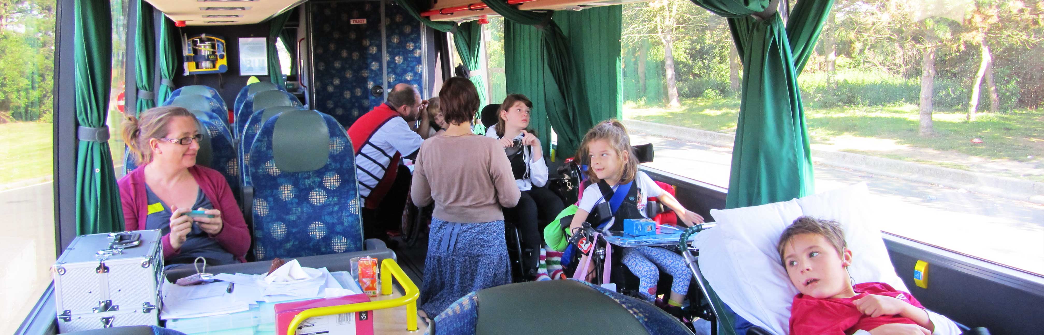 Passengers smiling and waving on board a Jumbulance