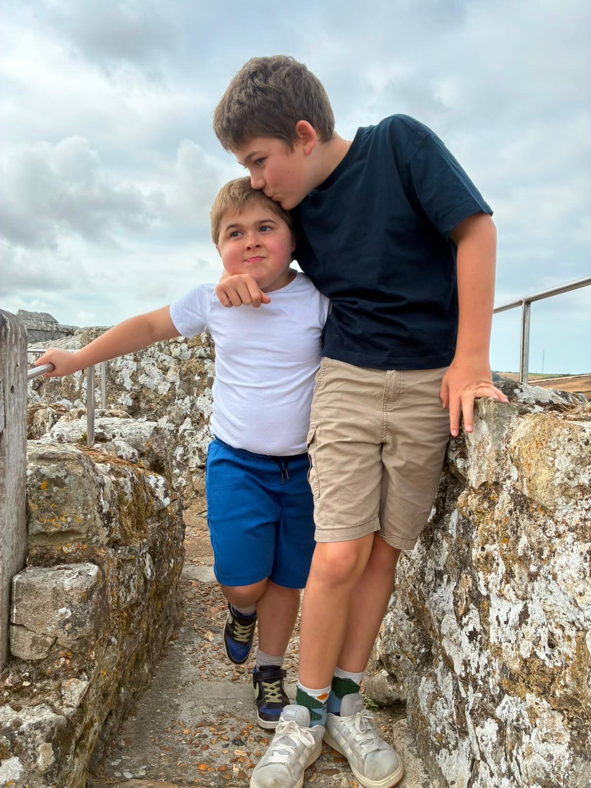 Two boys sharing a moment on a stone path