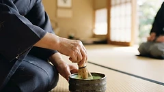 Japanese tea ceremony, hands whisking matcha on a tatami mat
